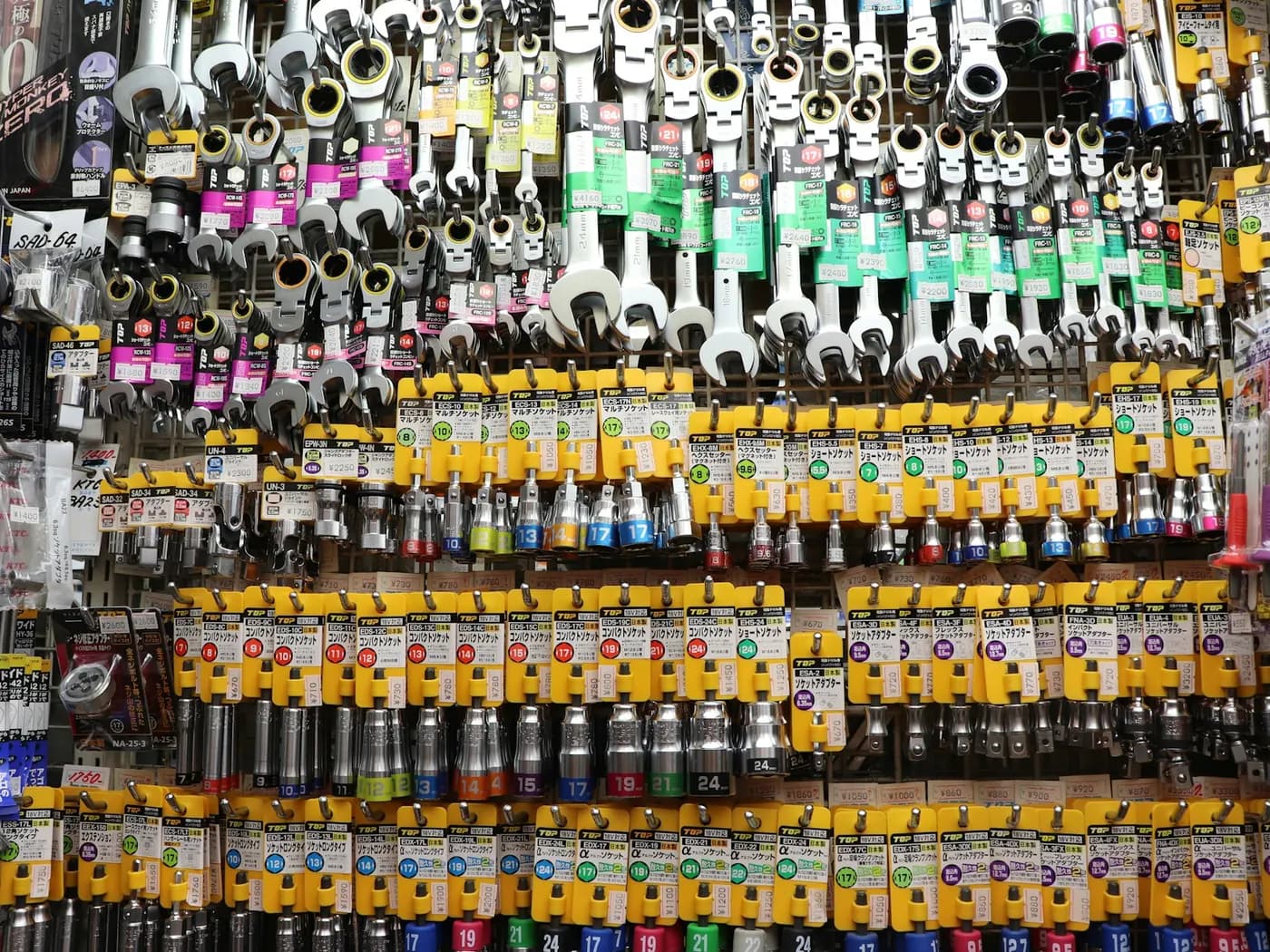 A supplier wall of maintenance stock: spanners, fittings and electrical consumables