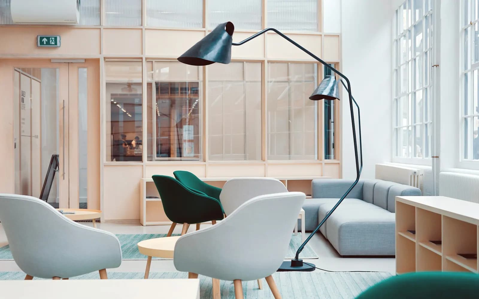 Modern coworking lounge with breakout seating, meeting rooms and shared work areas