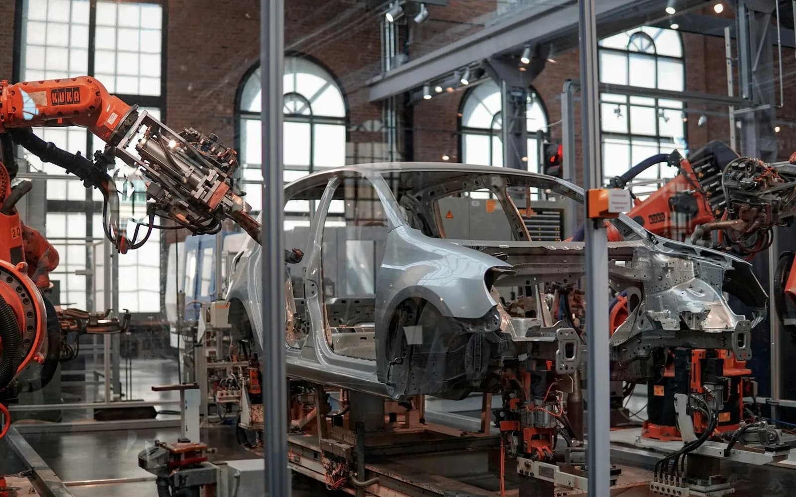 Manufacturing plant floor with an assembly line and robotic handling equipment in operation