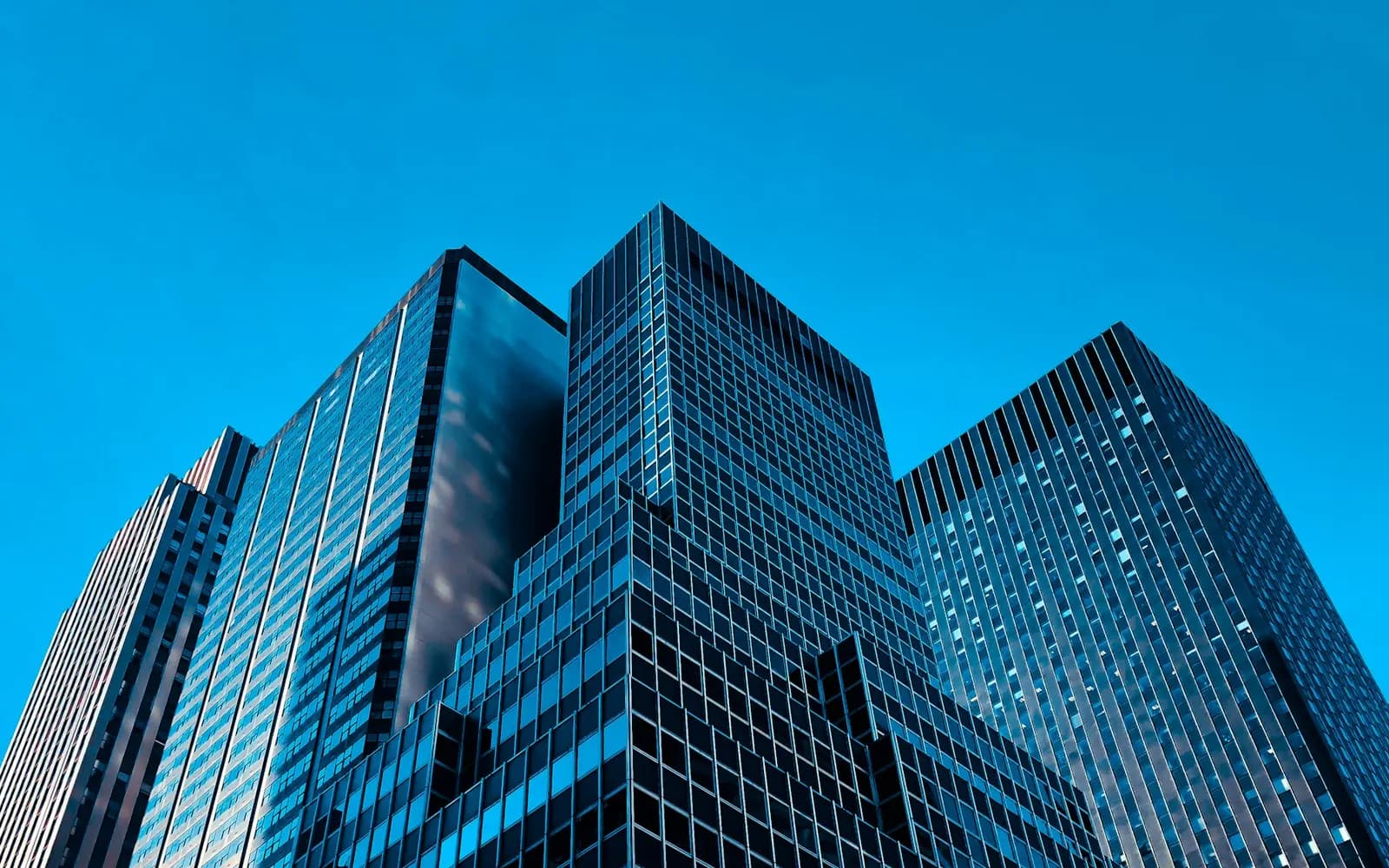 Commercial business park with multiple connected office buildings under a clear sky